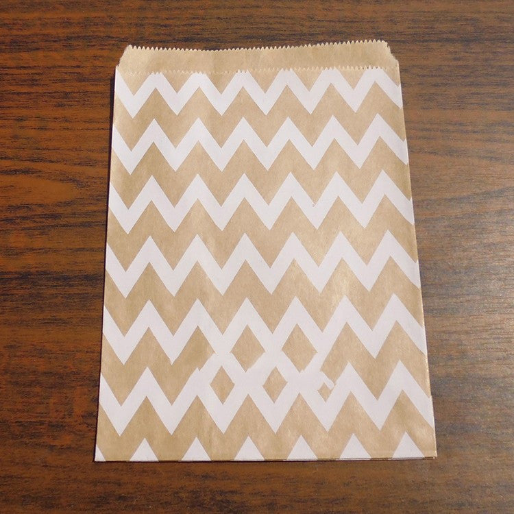 Kraft paper bag with white zigzag pattern on a wooden surface
