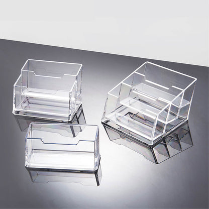 Set of three clear acrylic card holders on a reflective surface with a light gray background