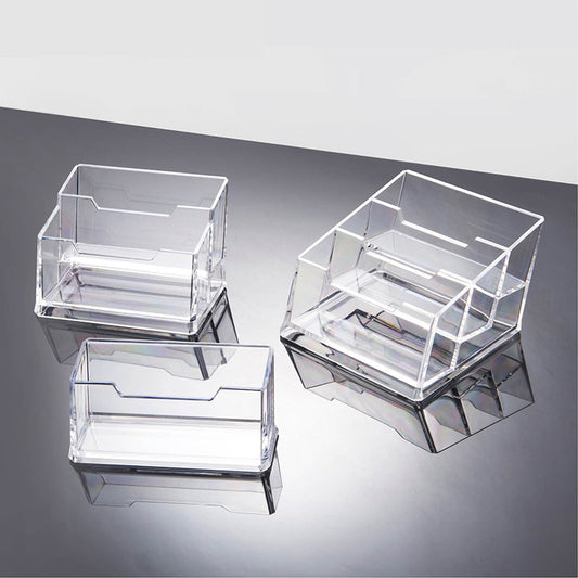 Set of three clear acrylic card holders on a reflective surface with a light gray background