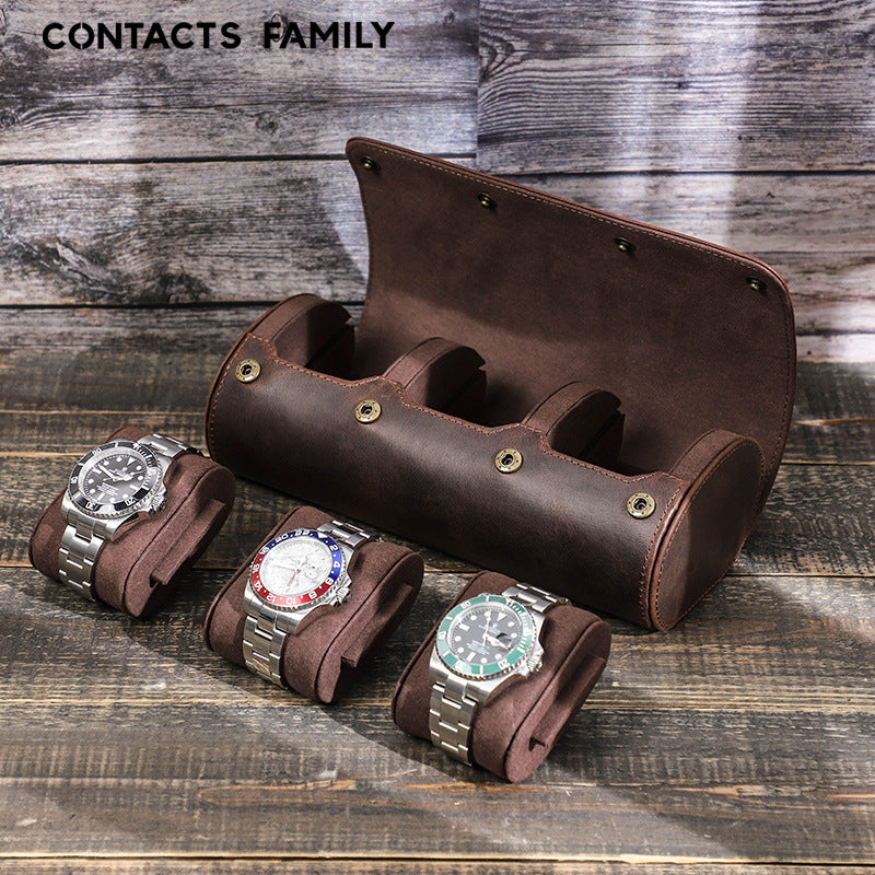 Brown leather watch holder with three Rolex watches on a wooden surface
