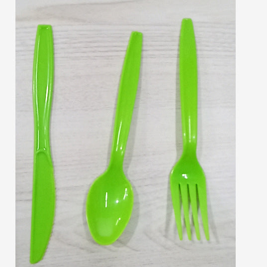 Three bright lime green plastic tableware pieces, including a knife, spoon, and fork, arranged vertically on a light wood-textured background.