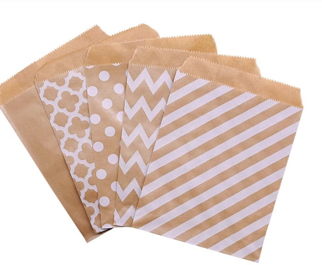 Set of brown paper bags with different patterns on a white background