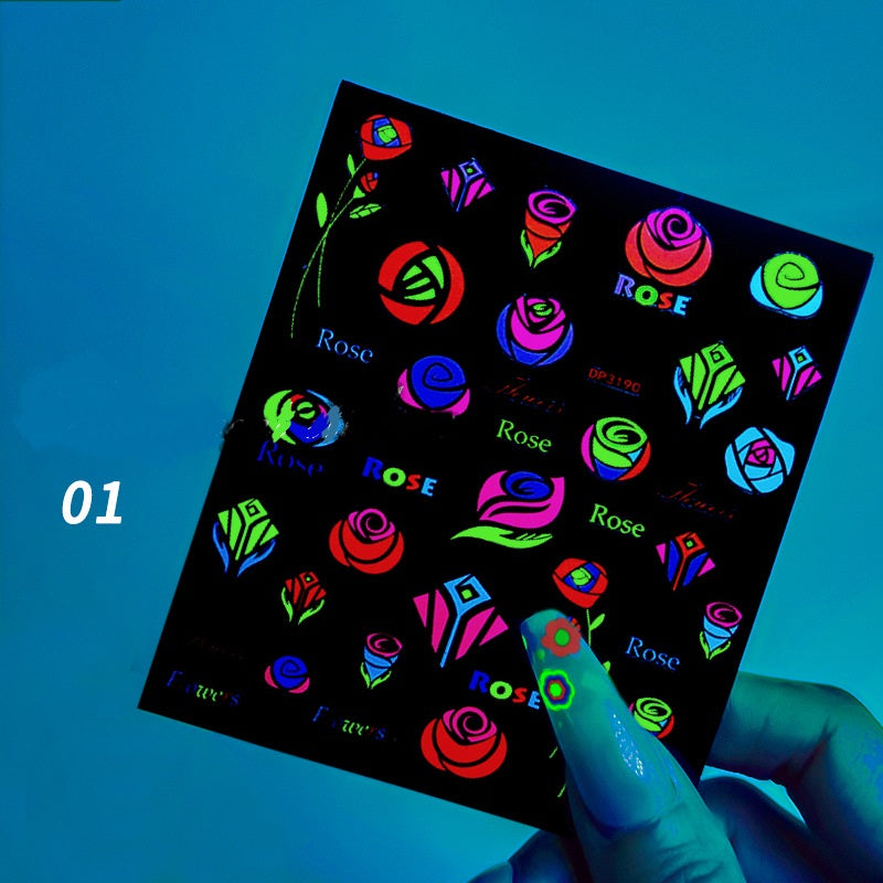 Sheet of fluorescent rose designs stickers held by a hand against a blue background