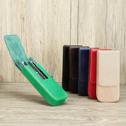 Green case with pens on a wooden surface and a row of colorful cases in the background.