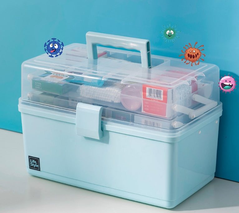 A light blue plastic medical storage box with a clear lid, shown on a white surface against a bright blue background. The box contains various medical supplies 
