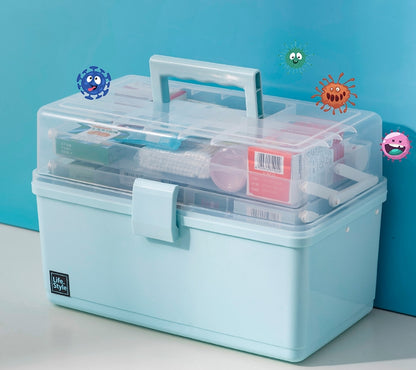 A light blue plastic medical storage box with a clear lid, shown on a white surface against a bright blue background. The box contains various medical supplies 