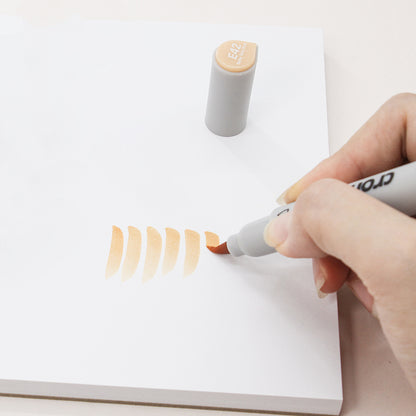 Person using a marker to draw on a white surface with a visible brand name.