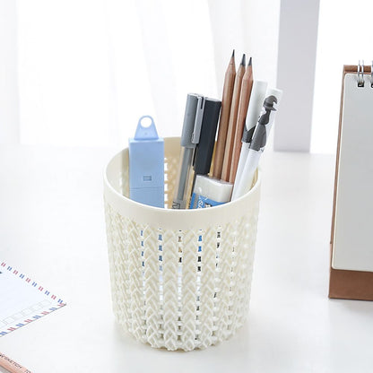 White woven pen holder with stationery items on a white background