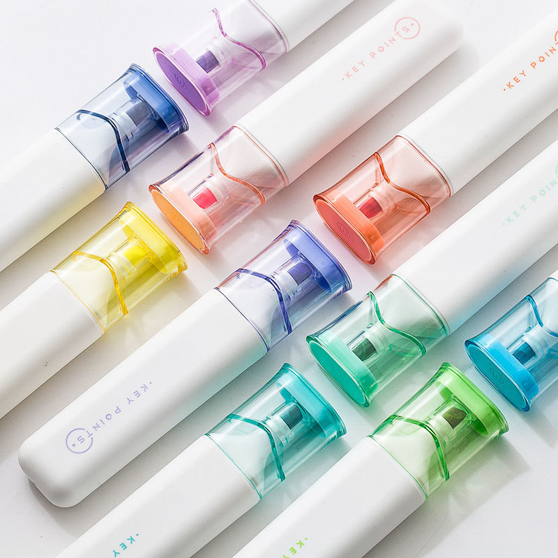 Set of colorful markers with white bodies on a light background