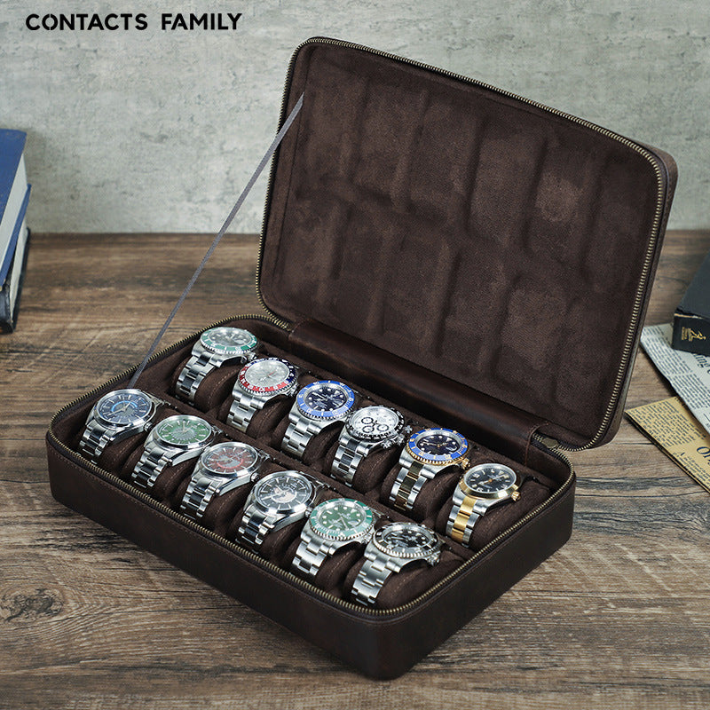 Brown watch display case with multiple watches on a wooden surface