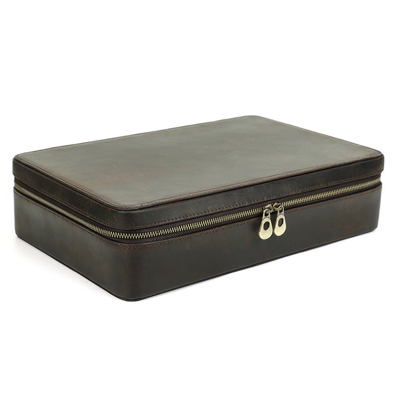 Brown leather jewelry box with gold zipper on a white background