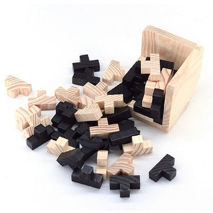 Wooden puzzle pieces in a box on a white background